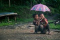 IMPHAL,MANIPUR, INDIA - Jul 19, 2019: Young and Cute Kids playing in their garden with an Umbrella