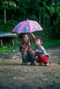 IMPHAL,MANIPUR, INDIA - Jul 19, 2019: Young and Cute Kids playing in their garden with an Umbrella