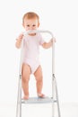 Impish little girl standing on top of ladder Royalty Free Stock Photo