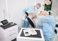 Dentist using dental implant machine during implantology procedure. Royalty Free Stock Photo