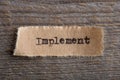 Implement - word on a piece of paper close up, business creative motivation concept Royalty Free Stock Photo