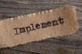 Implement - word on a piece of paper close up, business creative motivation concept Royalty Free Stock Photo