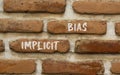 Implicit bias symbol. Concept words Implicit bias on red brown brick wall. Beautiful red brown brick wall background. Business