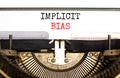 Implicit bias symbol. Concept words Implicit bias typed on white paper on old retro typewriter. Beautiful white background. Royalty Free Stock Photo