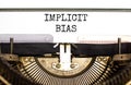 Implicit bias symbol. Concept words Implicit bias typed on white paper on old retro typewriter. Beautiful white background.