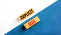 Implicit bias symbol. Concept words Implicit bias on wooden block. Beautiful white and blue table white and blue background.