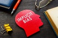 Implicit bias word on head shape on the desk. Royalty Free Stock Photo