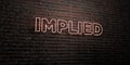 IMPLIED -Realistic Neon Sign on Brick Wall background - 3D rendered royalty free stock image