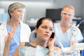 Impolite businesswoman on phone in dental office