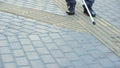 Impolite guy crossing road to blind man, impaired navigate with tactile paving