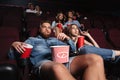 Impolite rude couple sitting in a cinema Royalty Free Stock Photo