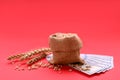 Import and export concept. Bag with grains, ears of wheat and money on red background