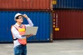 Import and export concept. Fore man shipper using tablet and computer laptop to monitor container and seal number status at