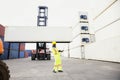 Import and Export concept. Foreman using laptop computer in the port of loading goods. Businessman with safety equipment working Royalty Free Stock Photo