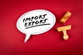 Import and Export concept. Speech bubble and wooden stamps on a red background Royalty Free Stock Photo