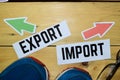 Import or Export opposite direction signs with sneaker and eyeglasses on wooden Royalty Free Stock Photo