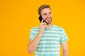 Importance of being communicative. Happy man talk on mobile phone yellow background. Verbal communication. Mobile