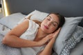 Importance of a good sleep. Young beautiful woman sleeps blissfully in the bed. Girl with regulated circadian cycle Royalty Free Stock Photo