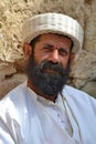 An important spiritual representative of the Yazid religion in Lalish, sits by the wall at the entrance to the shrine with the tom