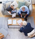 This is important to remember. Aerial shot of a group of businesspeople going through paperwork. Royalty Free Stock Photo