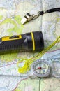 A hill walking map with compass torch and whistle.