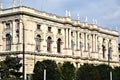 Imposing and historical palace, with columns on the facade and many statues on the cornice, in Vienna.