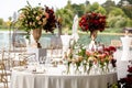 Lush decor with roses for the head table on the wedding day. Table decorated with flowers for outdoor wedding day Royalty Free Stock Photo