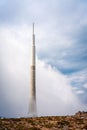 Imposing tall tower against a backdrop of cloudy skies, a majestic sight to behold