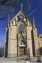 An imposing view of the Loretto Chapel under a blue sky in Santa Fe.