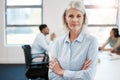 Impossible is not a fact, its an opinion. Portrait of a confident mature businesswoman standing with her arms crossed in Royalty Free Stock Photo