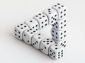 An impossible Penrose triangle is formed by a stack of white dice with black dots Royalty Free Stock Photo