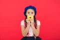 Impossible to resist fresh made donut. Girl hold glazed cute donut in hand red background. Kid smiling girl ready to eat