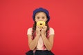 Impossible to resist fresh made donut. Girl hold glazed cute donut in hand red background. Kid smiling girl ready to eat