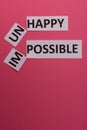 Impossible and unhappy text cut out. Possible concept. Success. Pink background. Copy space. Vertical orientation. View from above