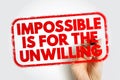 Impossible Is for the Unwilling appears in a bold red stamp frame held by a hand, delivering a strong motivational message about Royalty Free Stock Photo