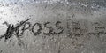 IMPOSSIBLE written on the sand Royalty Free Stock Photo