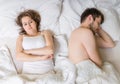 Impotence concept. Young man is sleeping in bed. Sad, disappointed and unsatisfied girlfriend.