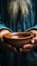 Impoverished elderly hands hold empty bowl, selective focus reveals hungers impact