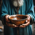 Impoverished elderly hands hold empty bowl, selective focus reveals hungers impact