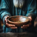 Impoverished hands cradle empty bowl, selective focus underlining hungers reality