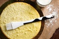 Impregnation with a milk of vanilla biscuit with a silicone brush. Baking a sponge biscuit cake. Cooking homemade cake Royalty Free Stock Photo