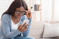 Impressed Black Girl In Eyeglasses Looking At Cellphone Screen With Disbelieve Royalty Free Stock Photo