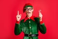Impressed crazy elf raise finger hold light bulb creative think concept wear green costume isolated on red shine color Royalty Free Stock Photo