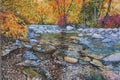 Painting in an Impressionistic Style of a Creek Flowing over Waterfall onto Rocks and Stones with Fall Trees in the background Royalty Free Stock Photo
