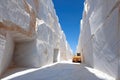An impressive Carrara marble quarry showcases its massive scale, with a machine for extraction creating a stark contrast to the Royalty Free Stock Photo