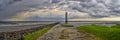 Impressive raincloud over the lighthouse in Fedderwardersiel, Germany