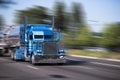 Impressive customized blue big rig semi truck with tank trailers Royalty Free Stock Photo