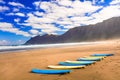 Surfboards on wide sandy beach Famara - famous beach for surfing Royalty Free Stock Photo