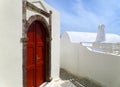 Impressive Greek Style Door Casing with Deep Red Door on Pure White Building at Santorini