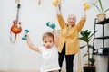 Impressive grey-haired granny doing phisical exercises with her grandson Royalty Free Stock Photo